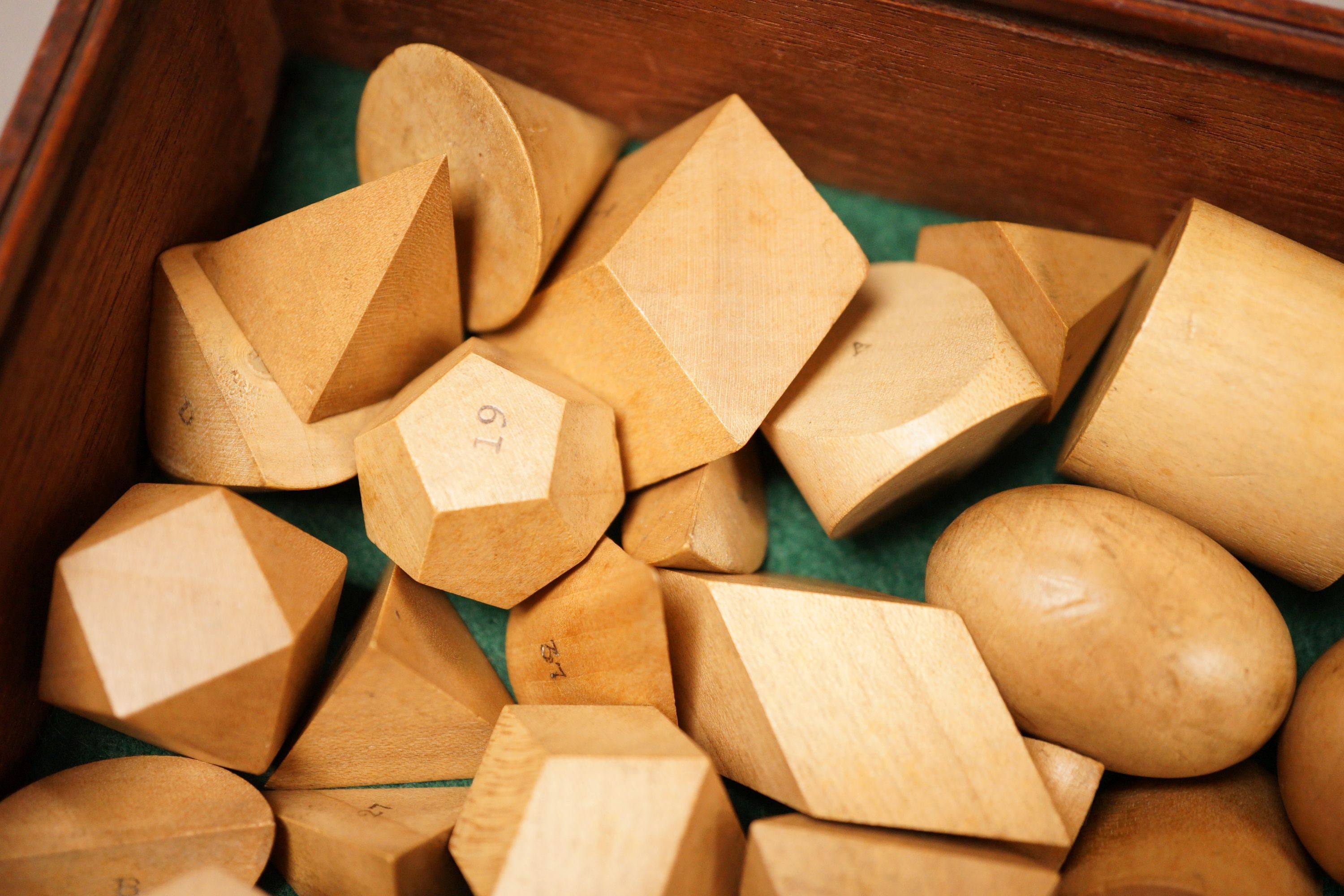 A mahogany cased set, Edwards Geometrical Planes and Solids': 19th century educational carved wooden geometry instructional set, with paper label to cover